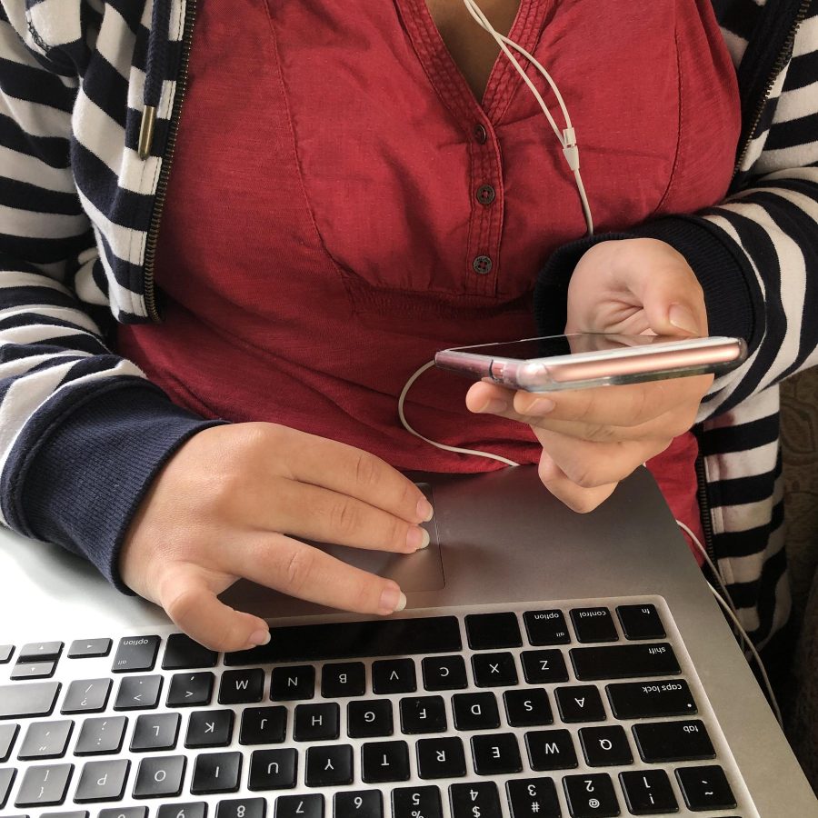 millennial-woman-using-a-laptop-computer-and-smart-2025-03-08-06-13-41-utc